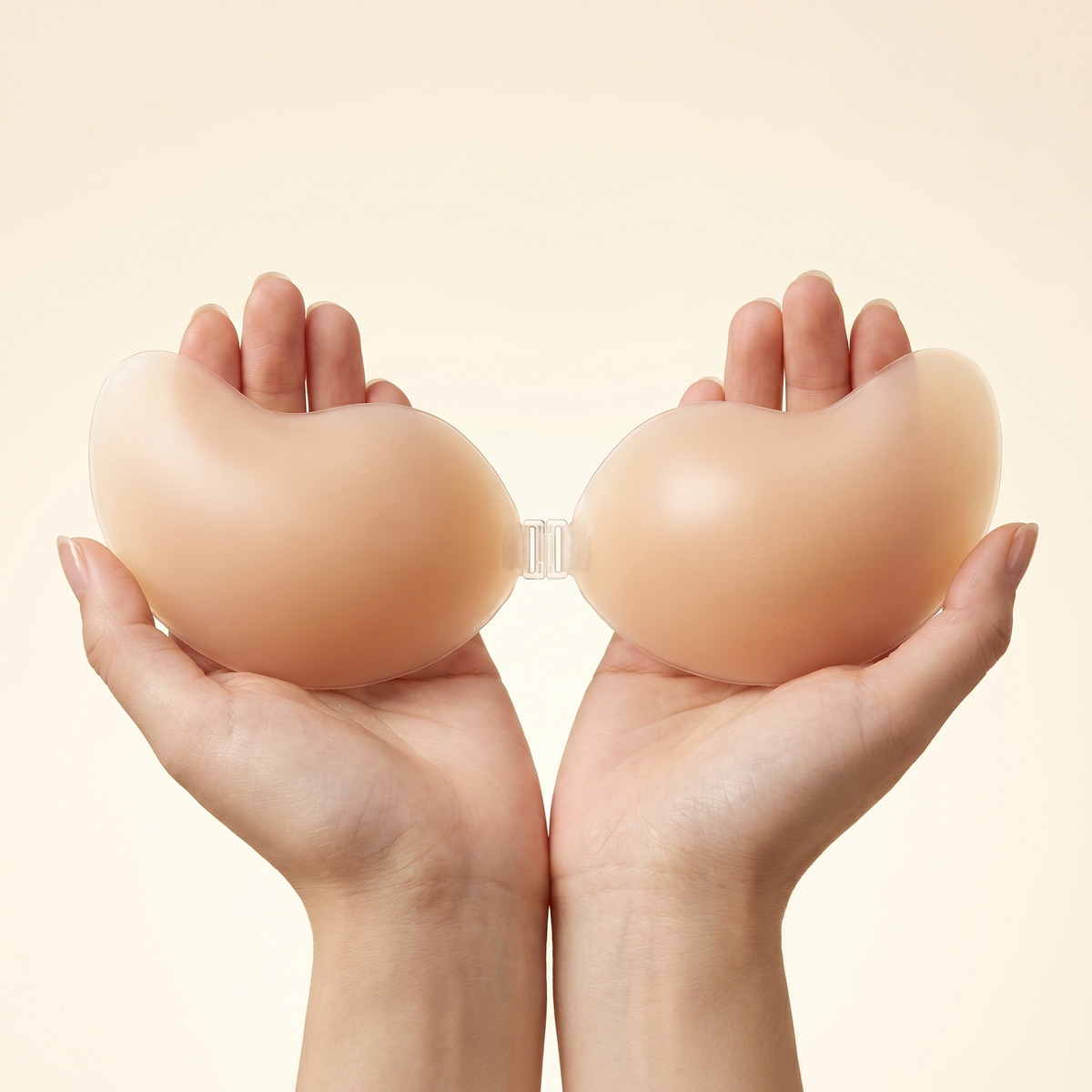Bare Cleavage Bra held in hands on light cream background